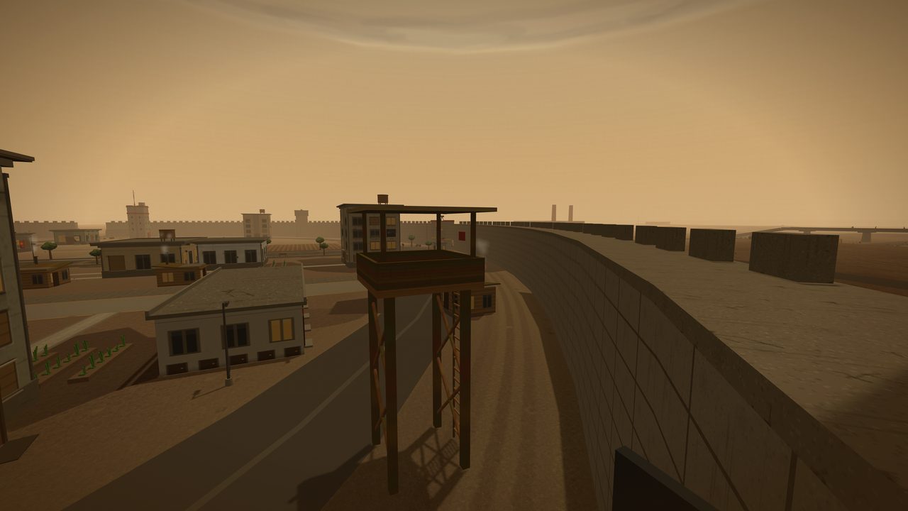 The view from the top of the settlement's perimeter wall, looking along the curving rampart until it vanishes into haze. A timber watchtower on tall stilts, reached by a ladder, stands over the road just inside the wall. Below and to the left are tin-roofed houses, a street lamp and rows of green vegetable plots; outside the wall to the right, concrete anti-vehicle blocks are scattered across dead orange ground, with two distant chimneys and a long ruined bridge on the horizon.